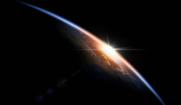 Stock image of sun reflecting off earth in space